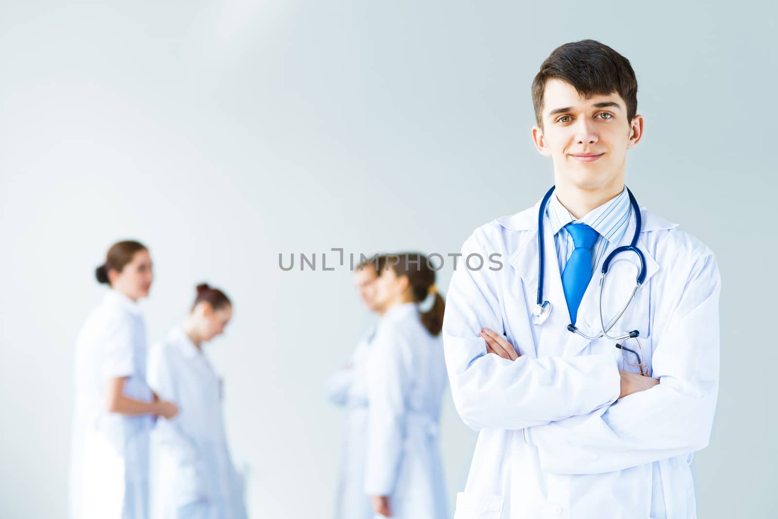 Portrait of a successful young doctor and hospital staff