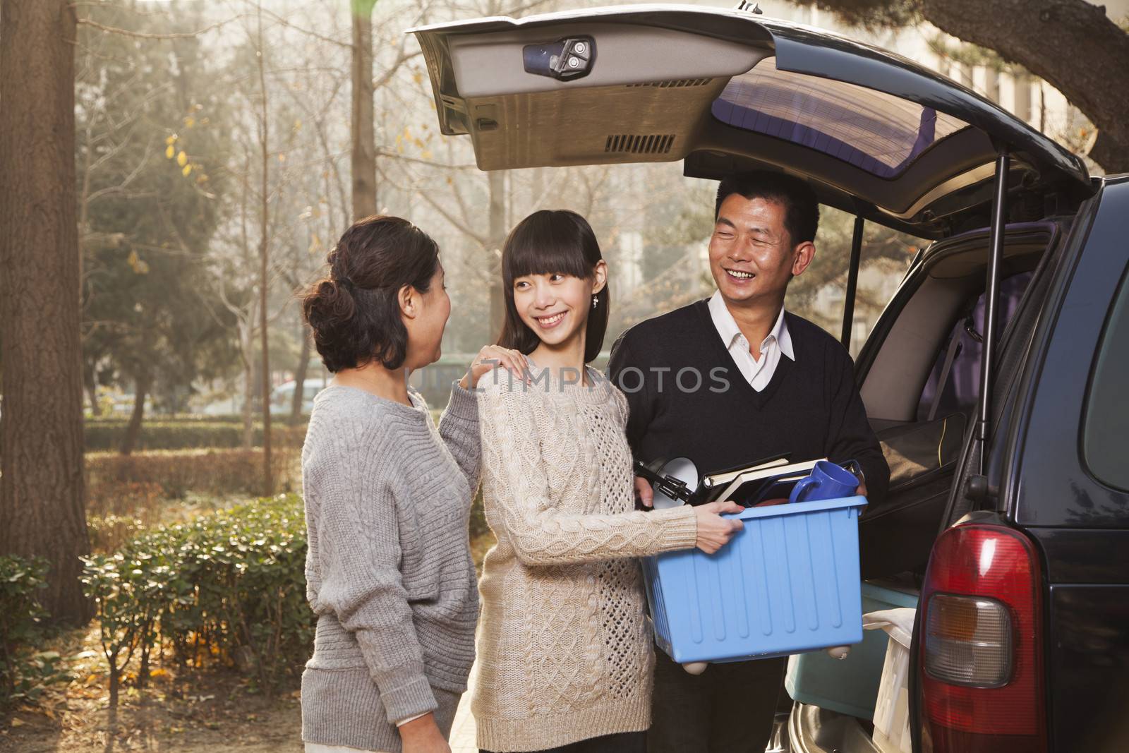 Family unpacking minivan for college, Beijing by XiXinXing