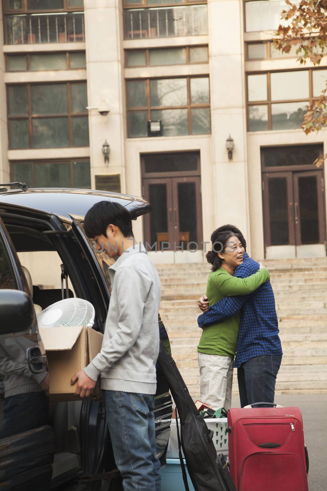 Family moving their son into dormitory on college campus by XiXinXing