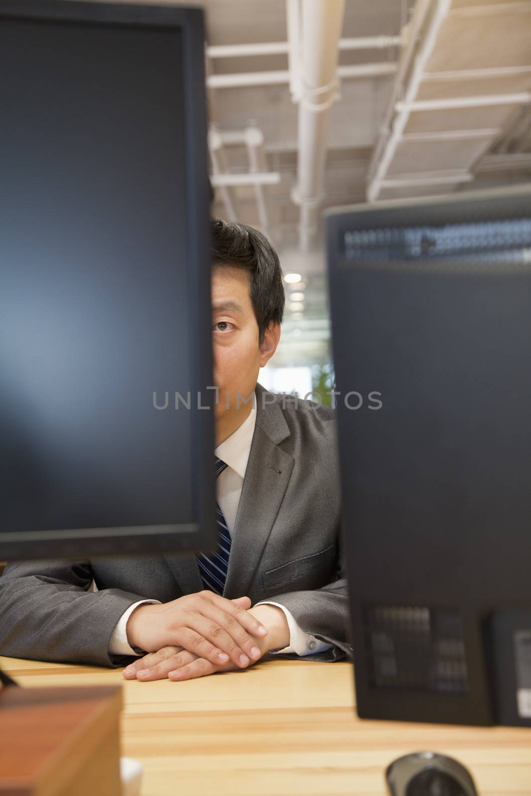 Businessman Looking at Computer in the Office