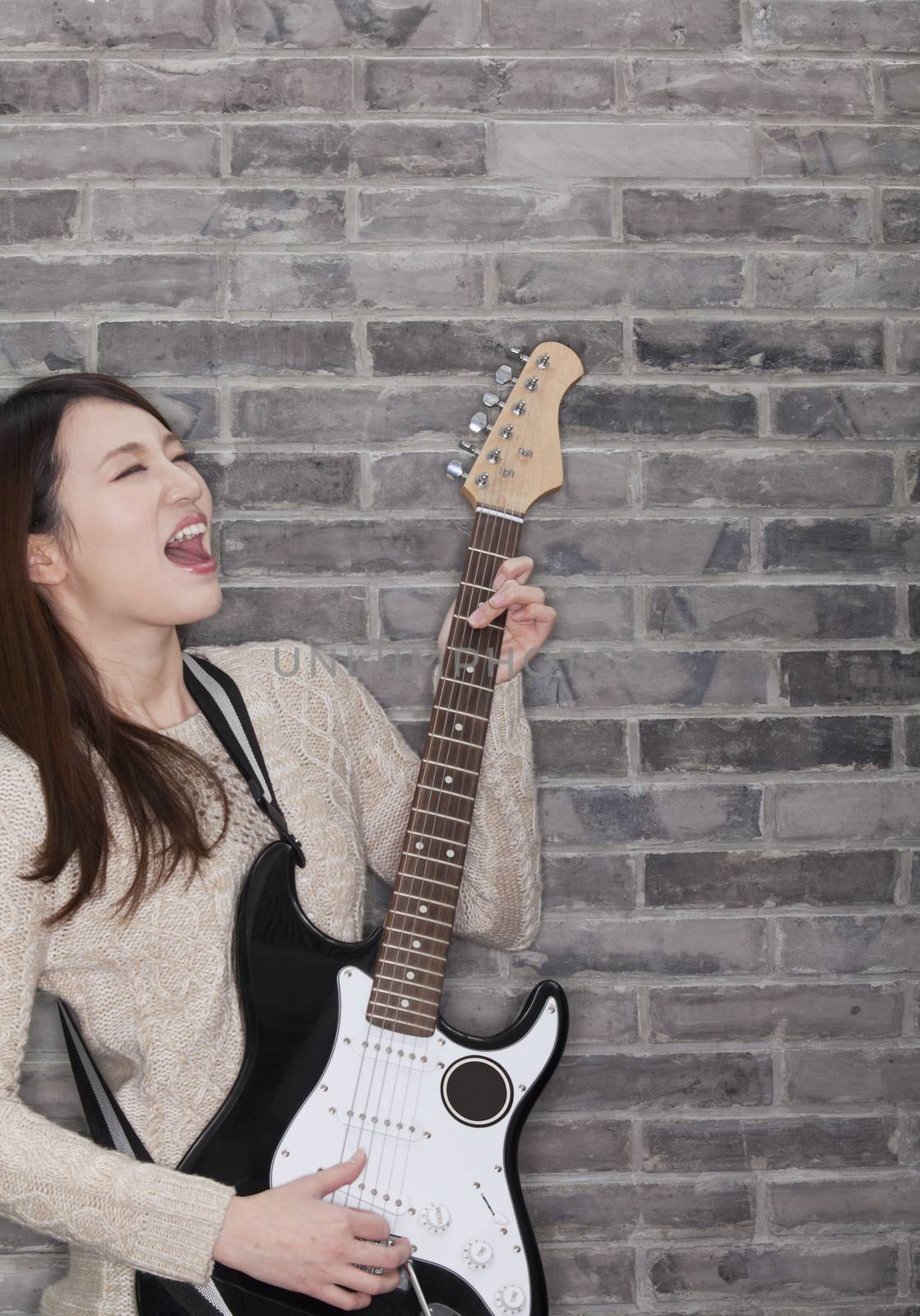 Young Woman Playing a Electric Guitar