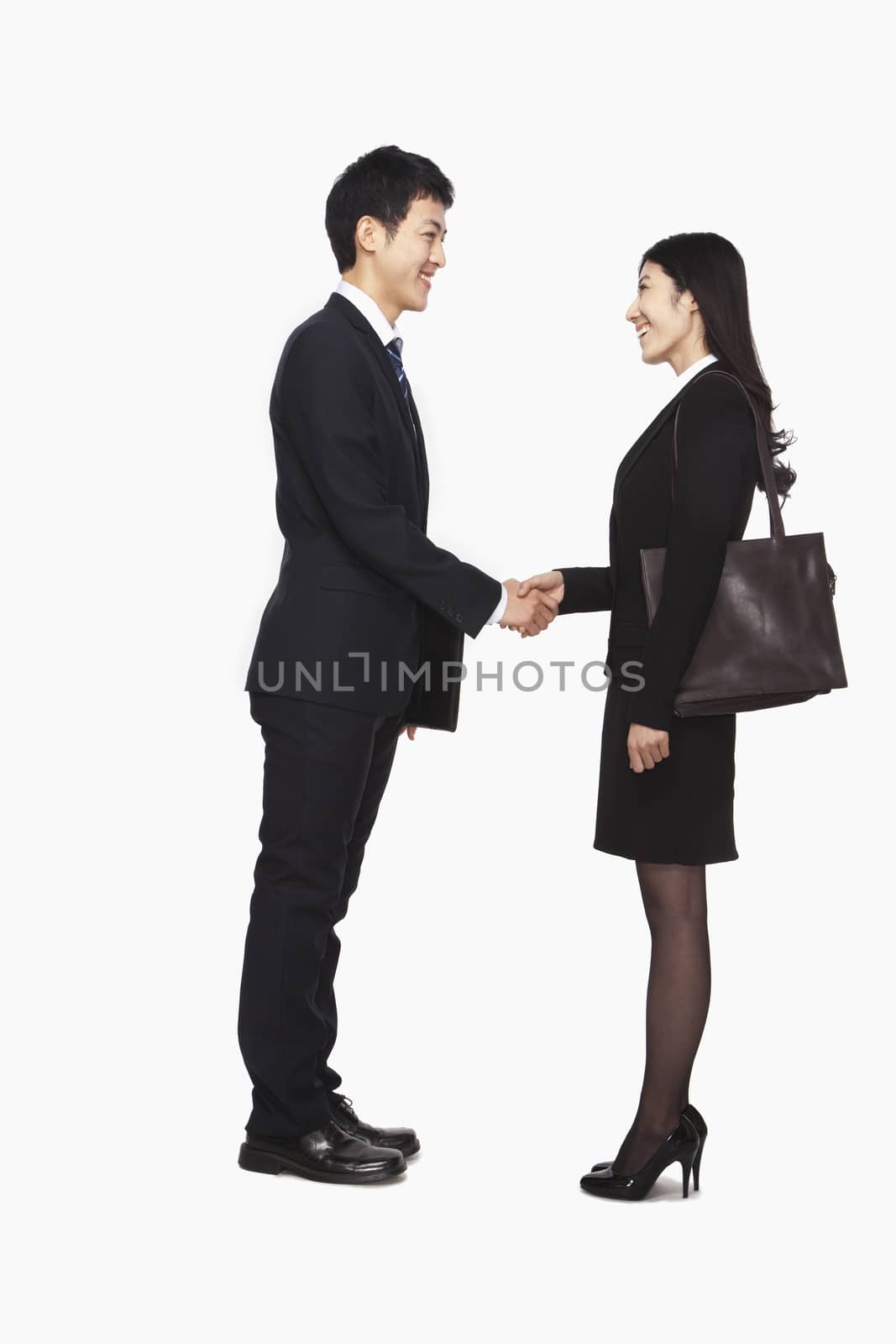 Businessman and businesswomen shaking hands by XiXinXing