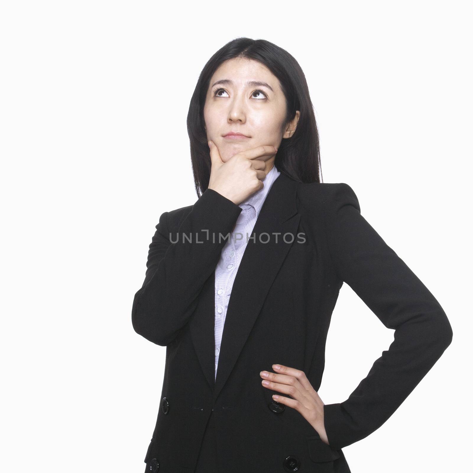 Businesswoman with hand on chin thinking