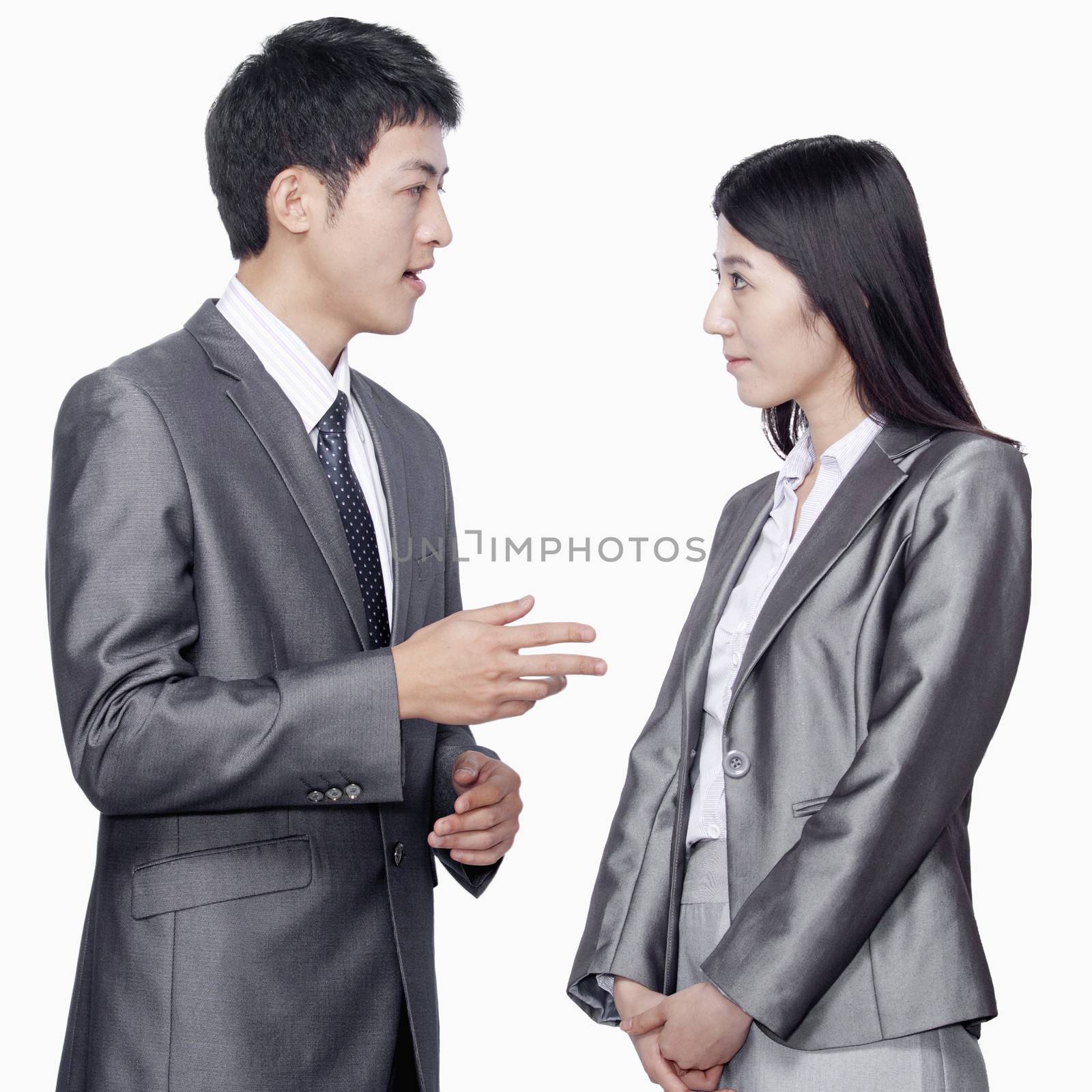 Businessman talking to businesswoman by XiXinXing