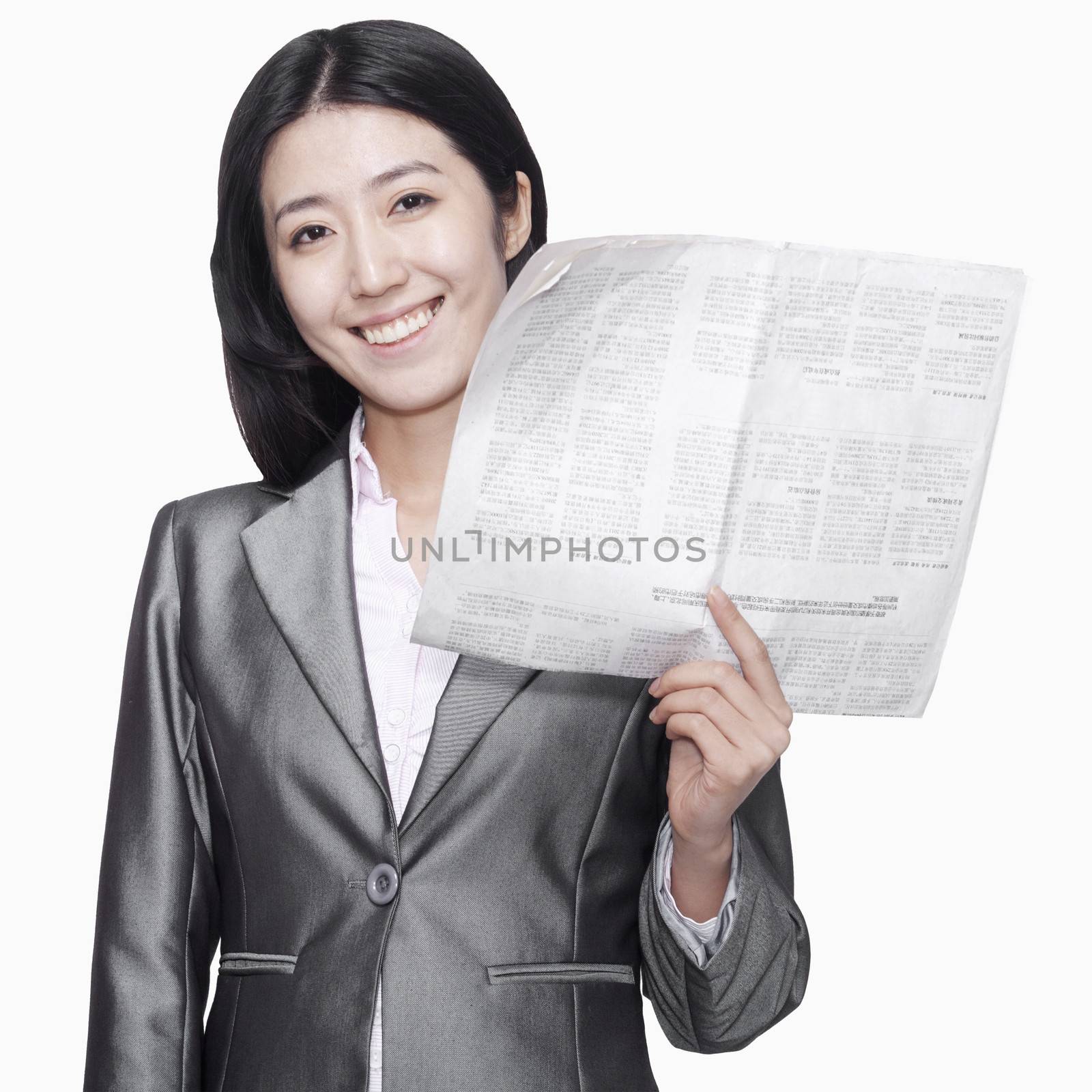 Businesswoman standing with newspaper