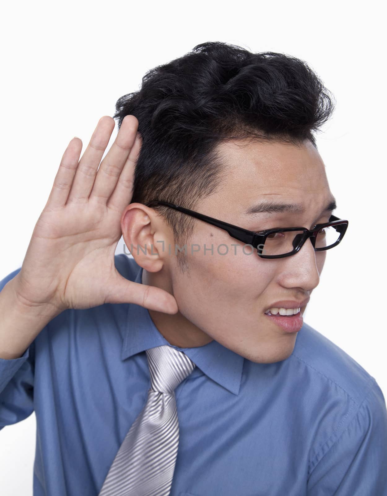 Businessman Holding Hand Up to Ear