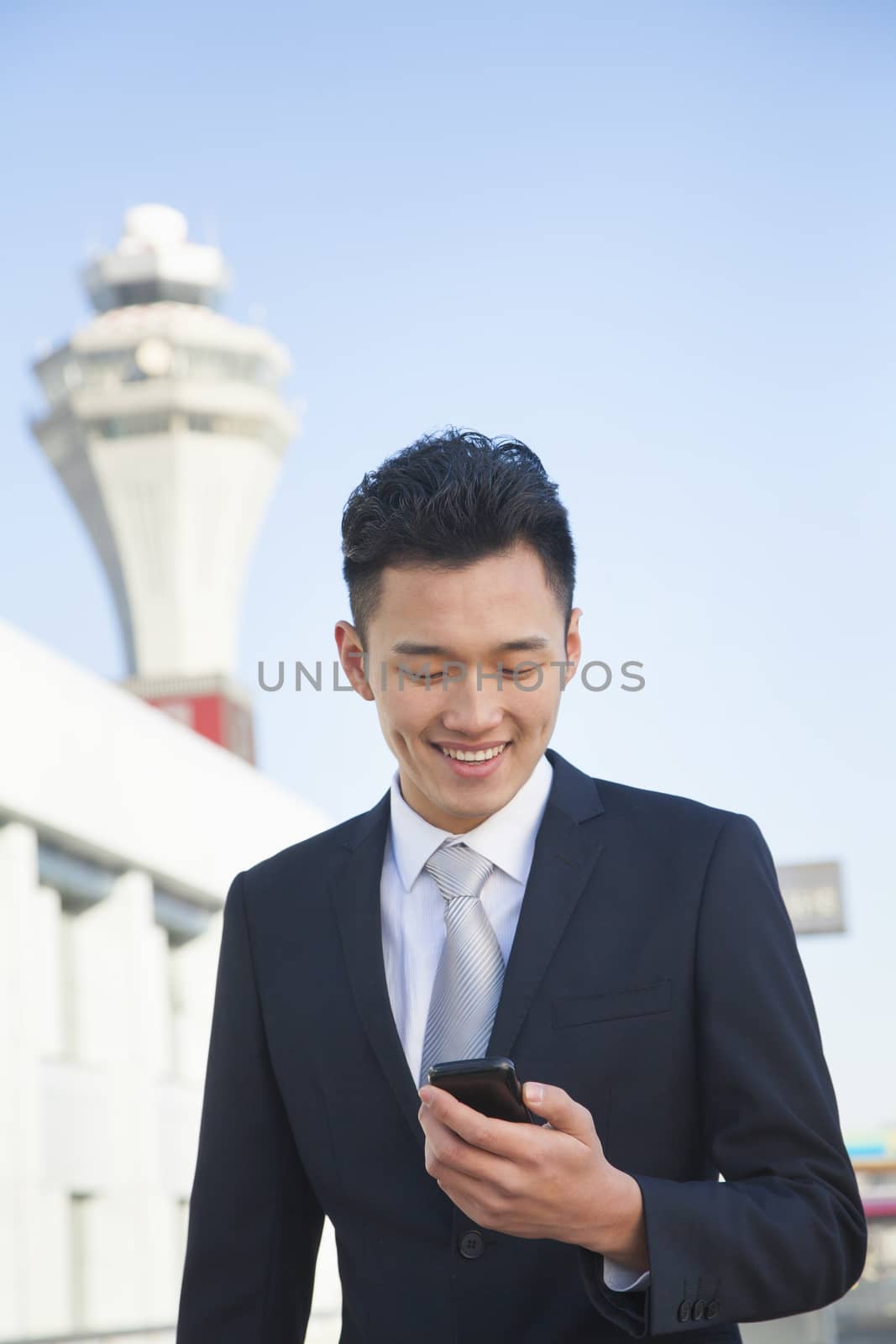 Traveler looking at cell phone message at airport