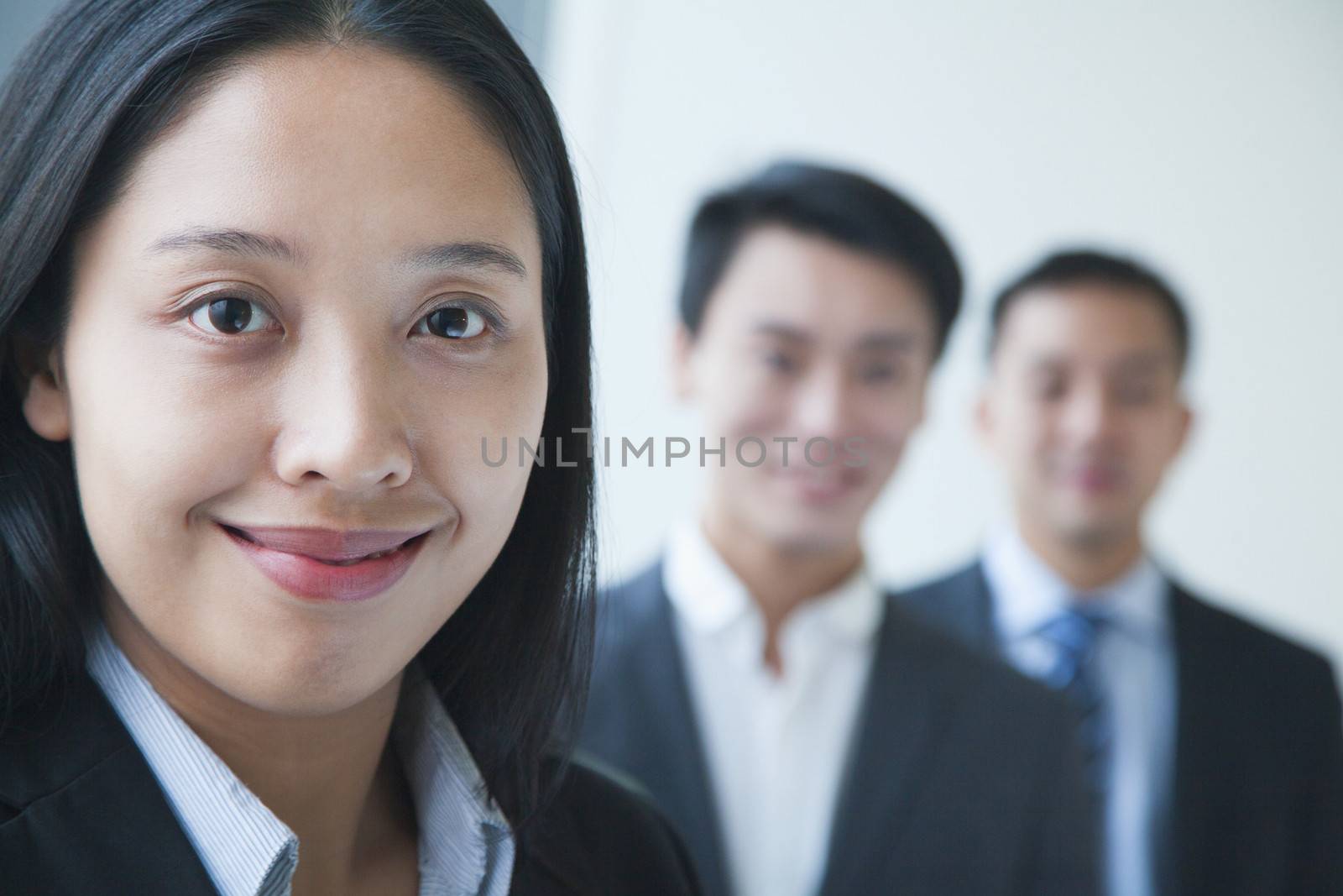 Businesswoman with co-workers portrait