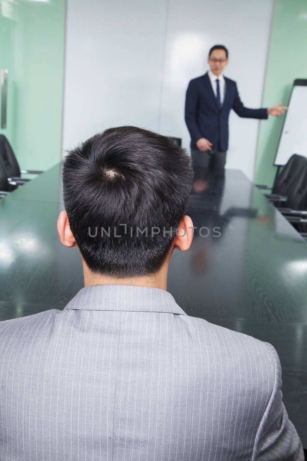 Rear View of Businessman Listening to Presentation by XiXinXing