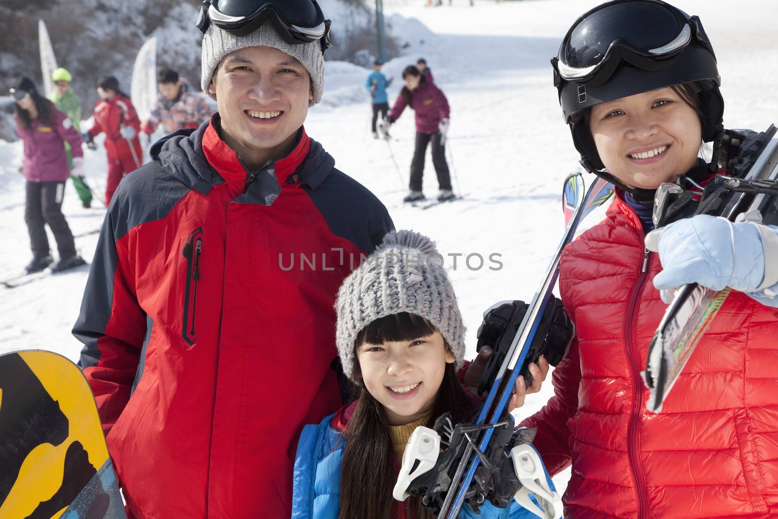 Family Smiling in Ski Resort by XiXinXing