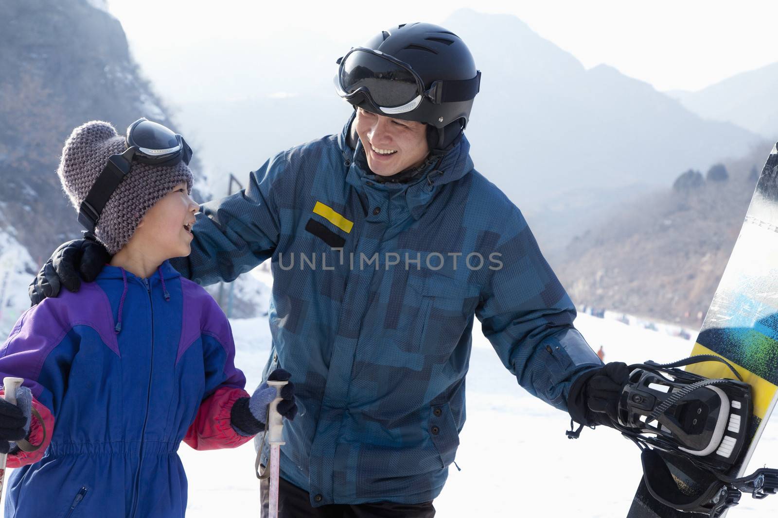 Father and Son with Ski Gear in Ski Resort