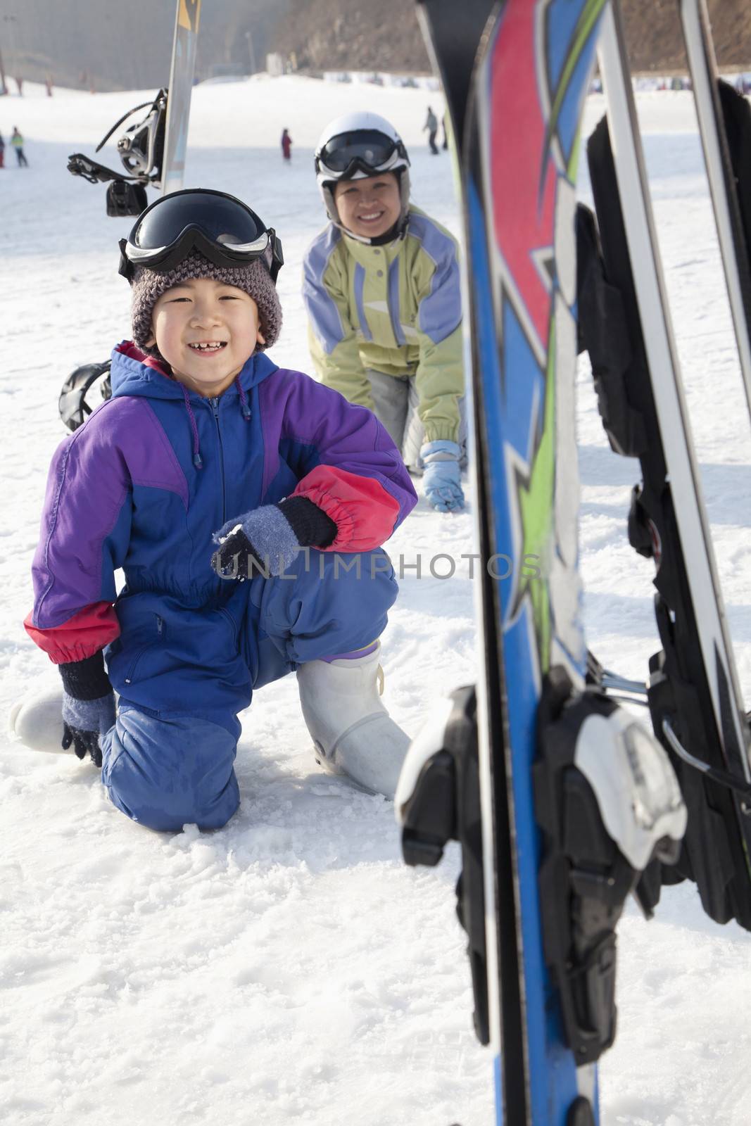 Mother and Son Smiling in Ski Resort by XiXinXing