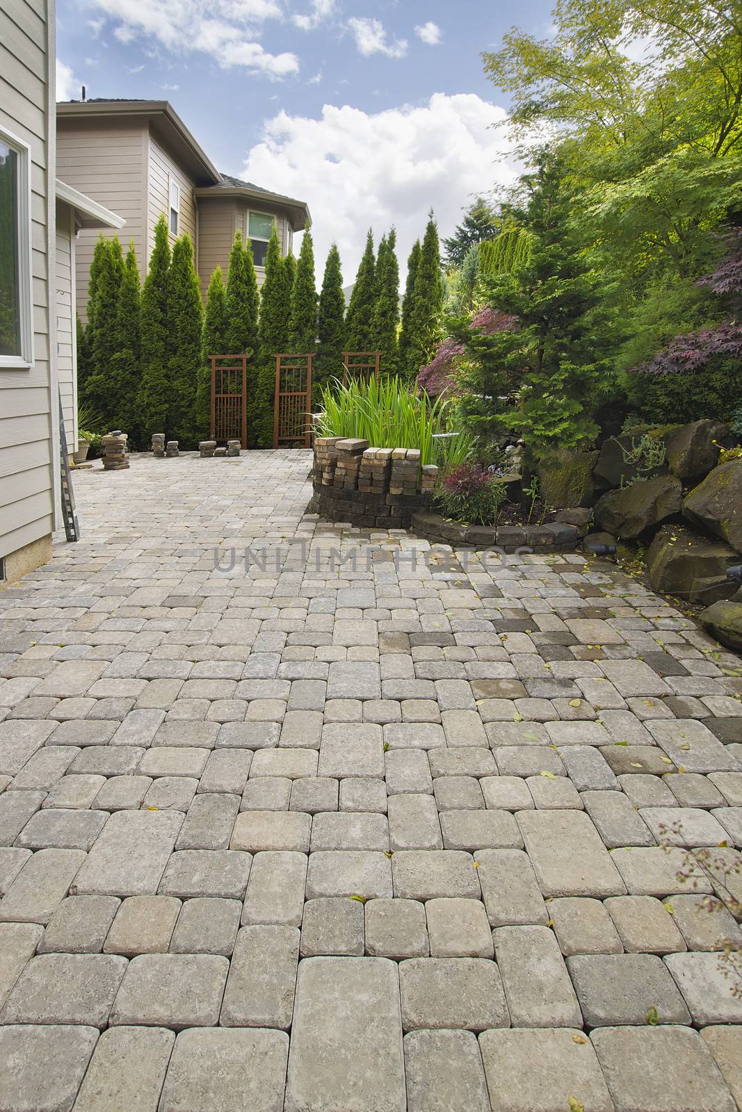 Garden Backyard Hardscape Brick Pavers Patio with Pond Trees Natural Rocks Landscaping
