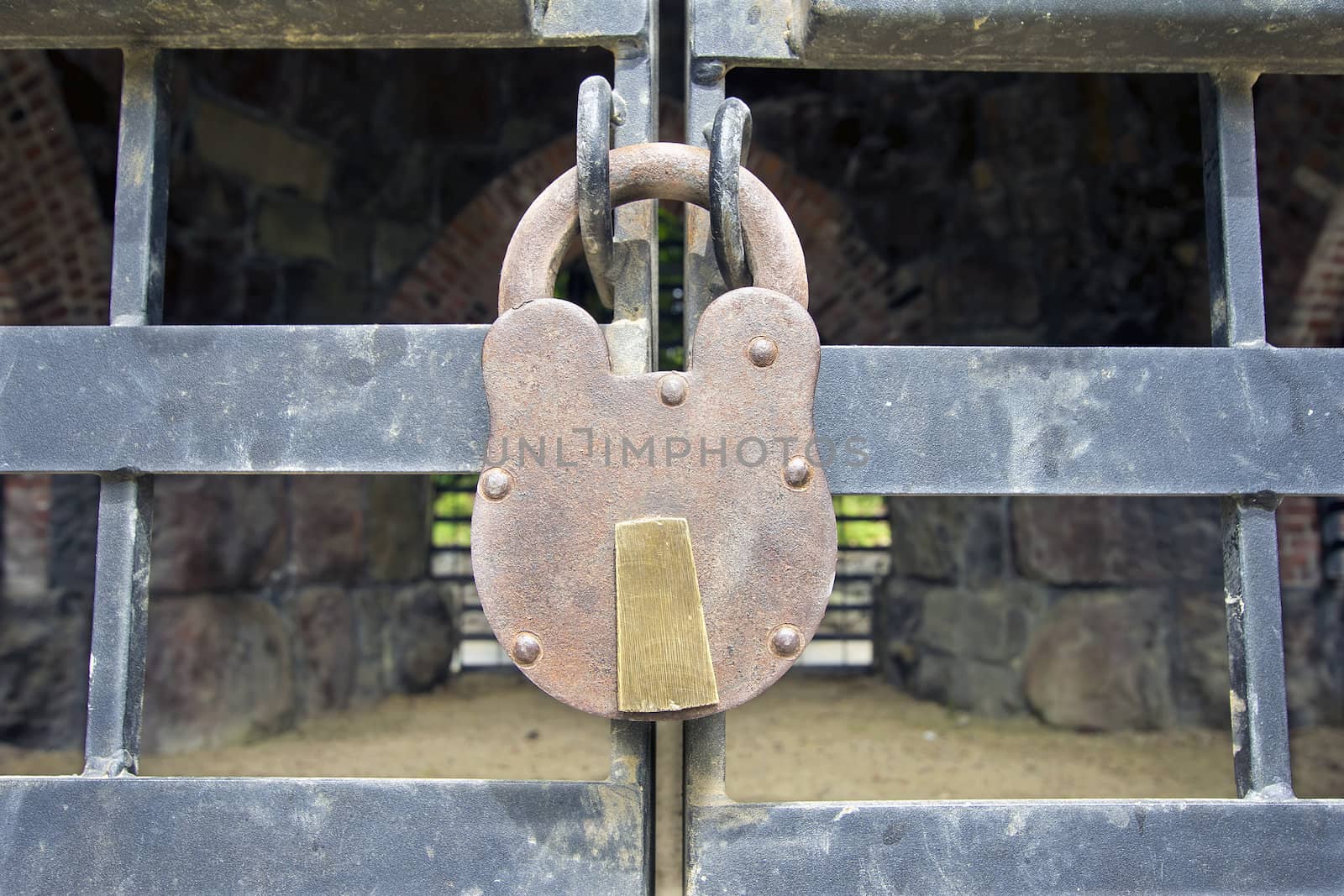 Old Iron Padlock on Gated Historic Building Exterior