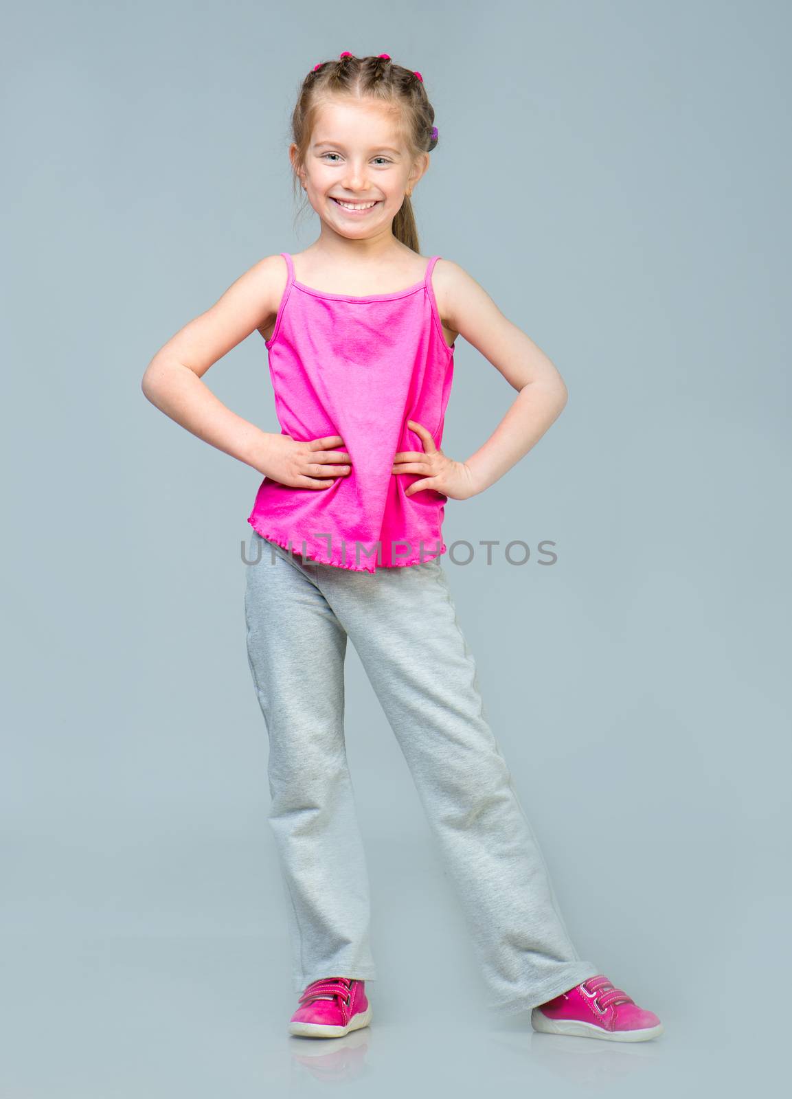 Cute Smiling Little girl gymnast in studio