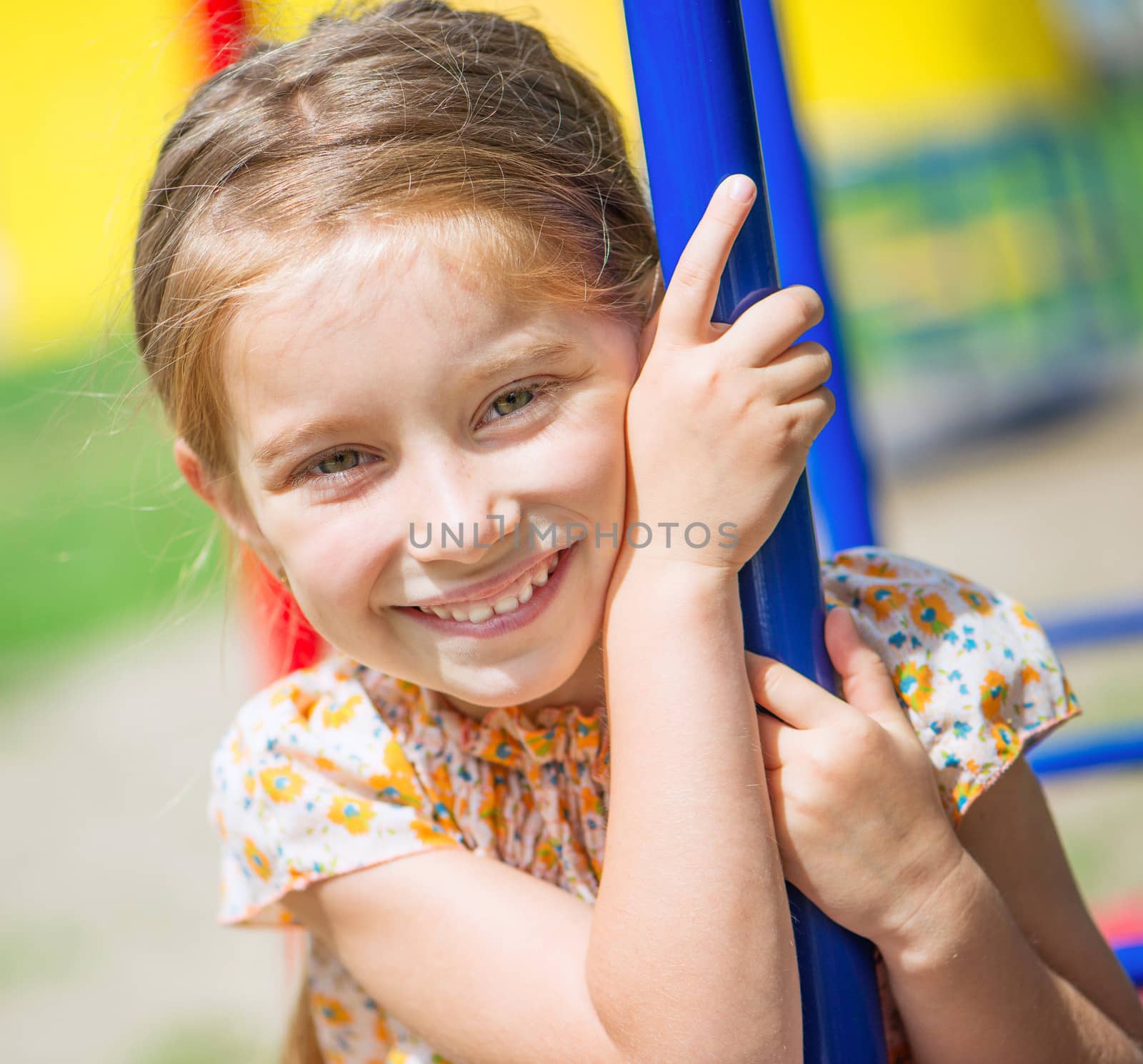 cute smiling little girl on the playground