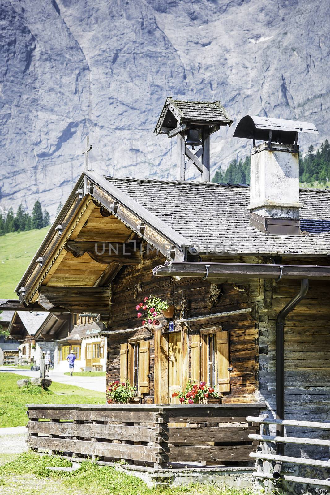 Huts in the Austrian Alps at a place called Hinterriss, Eng on a sunny day with rocky mountains in the background