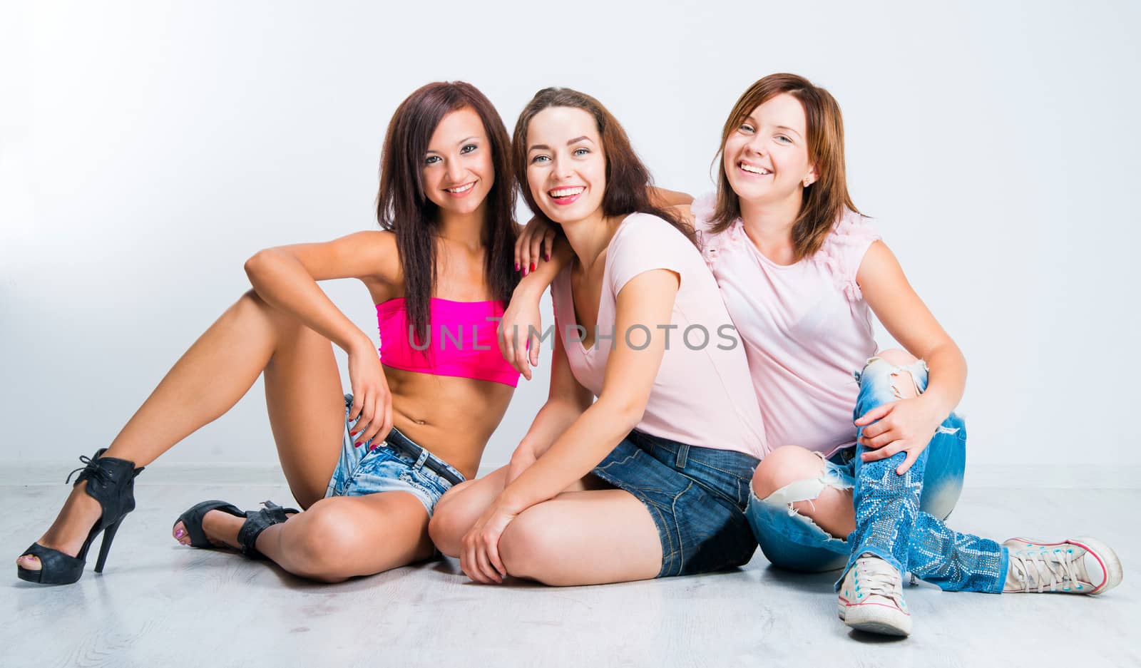 teenage girls smiling on light background