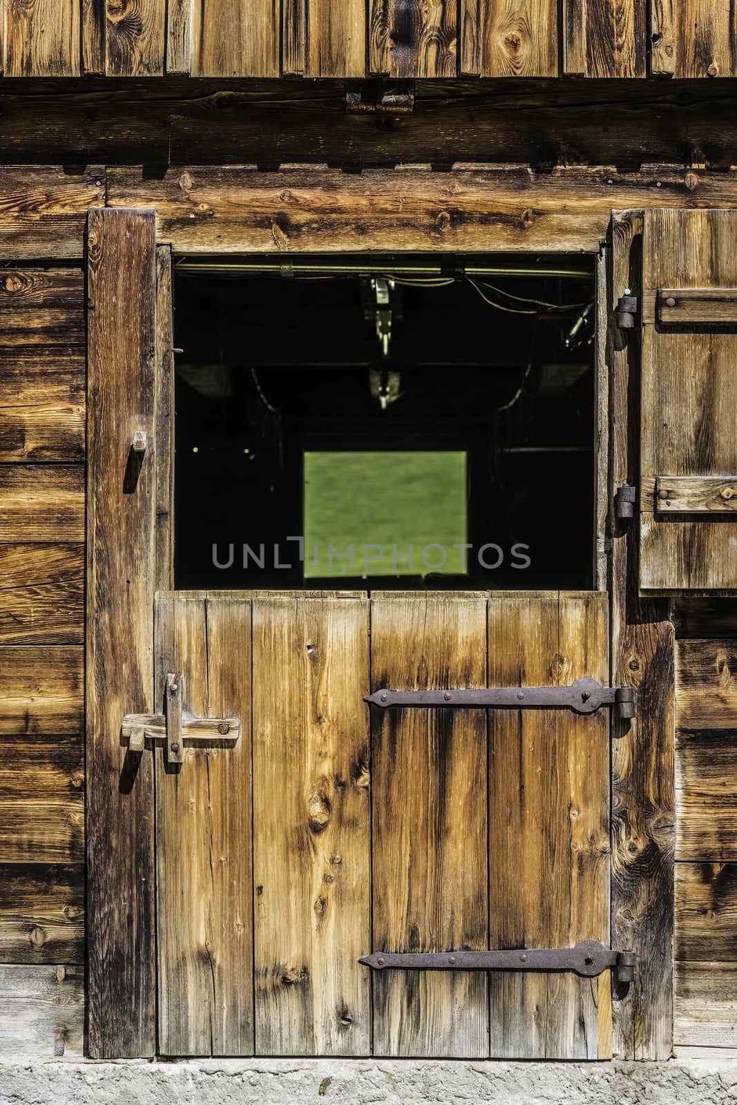 Picture of a wooden door of a stable in the Alps