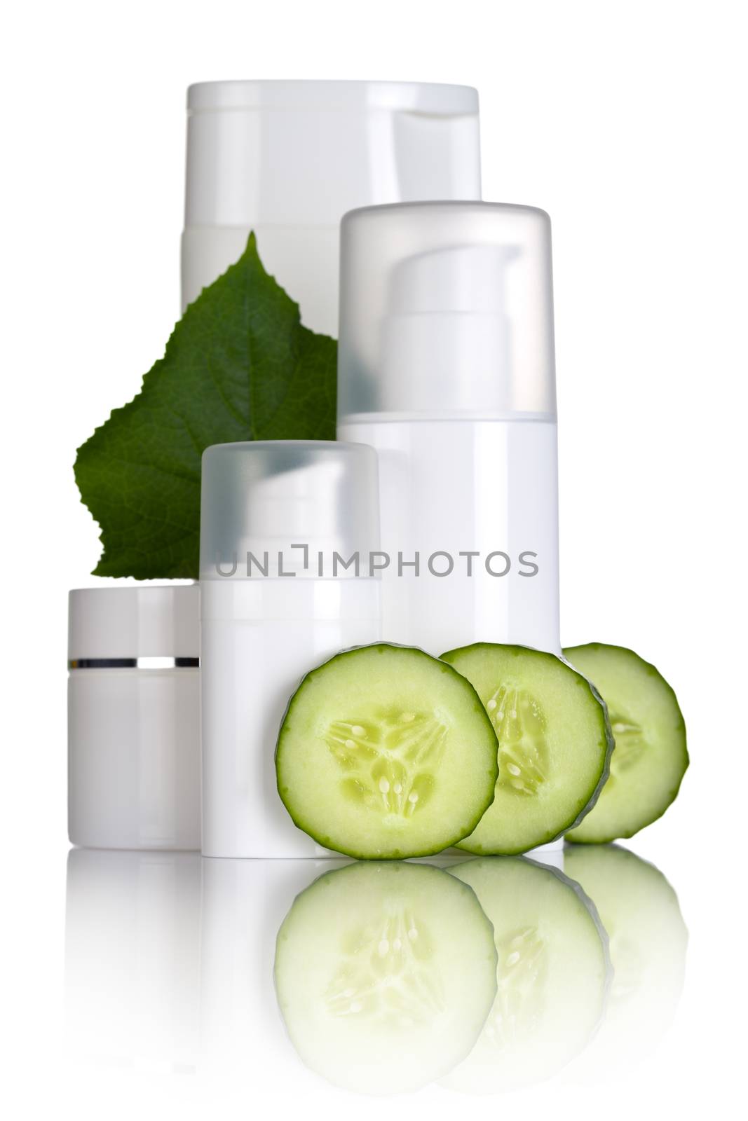 Cosmetic bottles with cucumber slices and leaf on white background