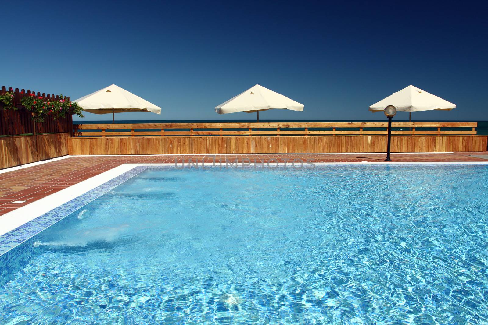 view from the pool with umbrellas near the beach