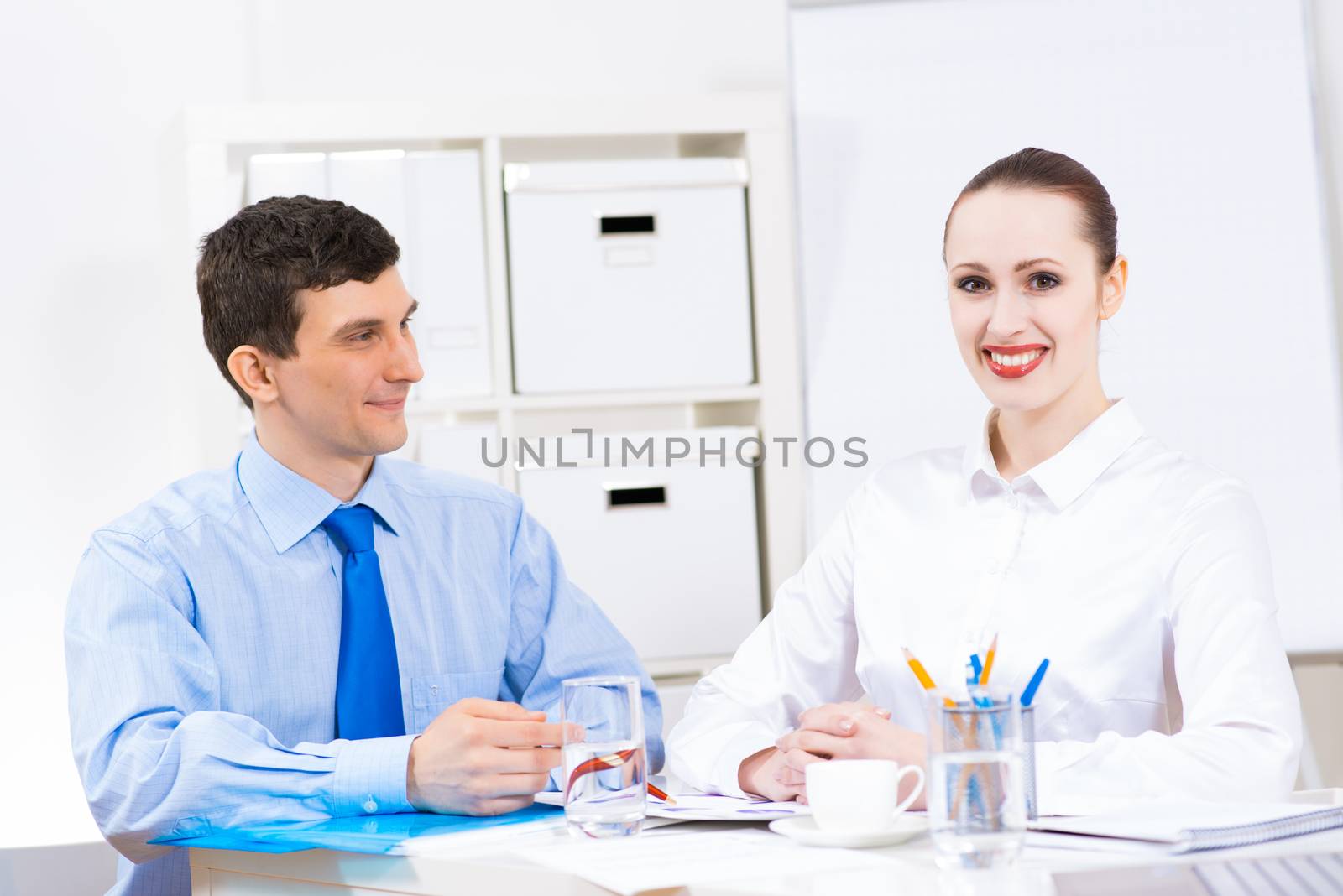 colleagues discuss the reports at a desk in the office, working together in business