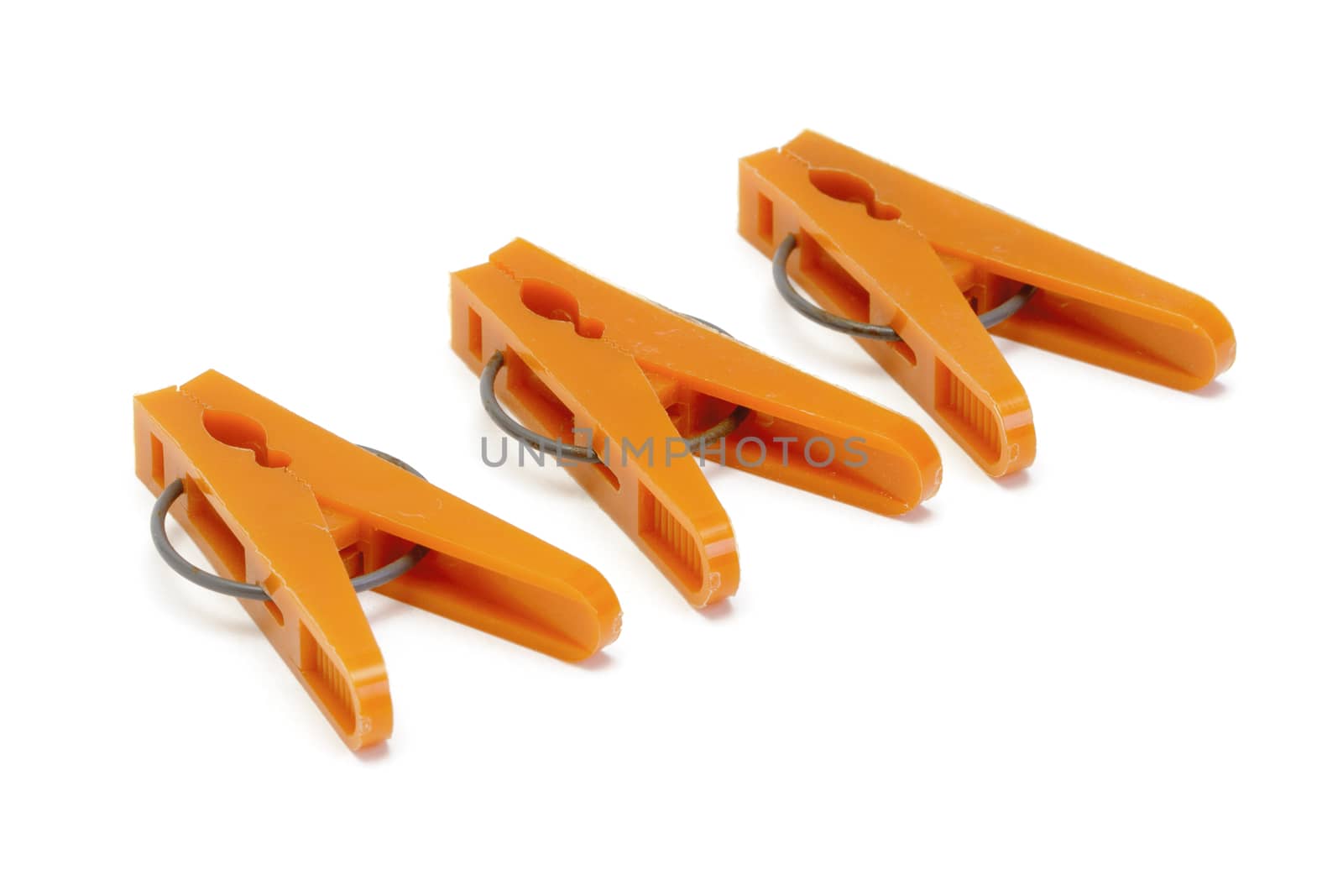 Orange plastic clothespins by marslander