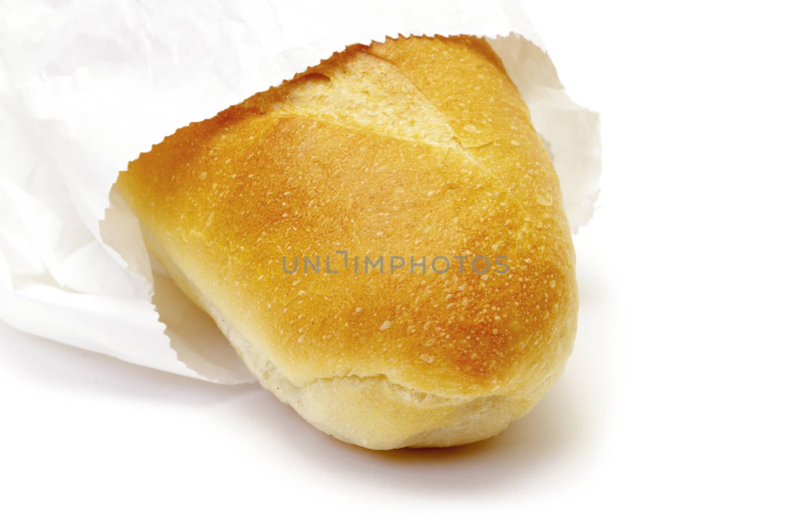 Wheat bread in paper packet on white