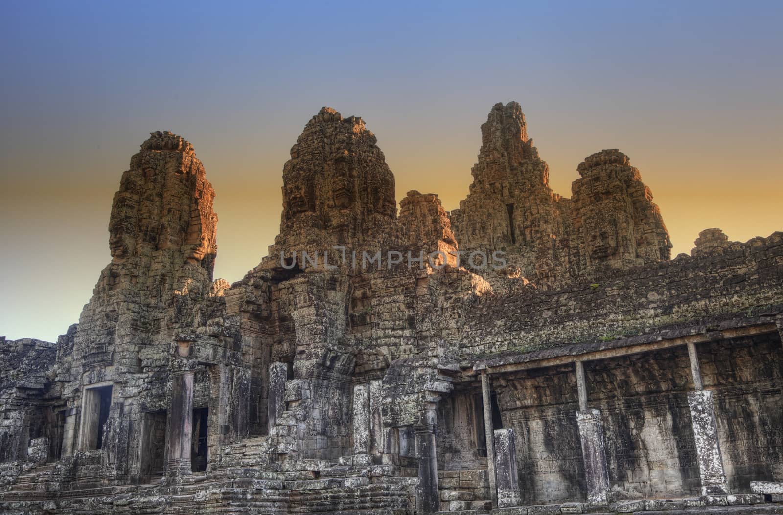 Bayon temple at sunset in Angkor Cambodia by ldambies