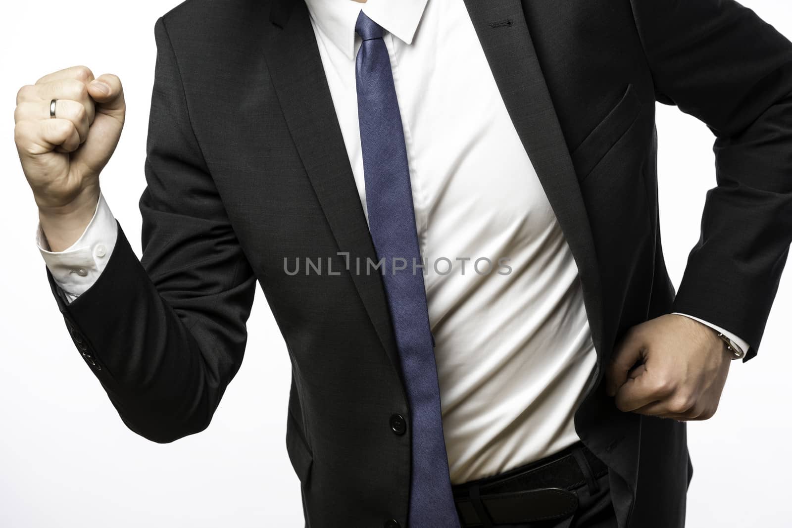 Businessman in dark suit on the move with clenched fists, isolated on white background