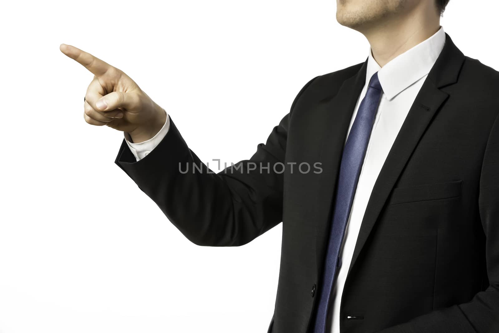 Businessman in dark suit pointing with his finger, isolated on white background