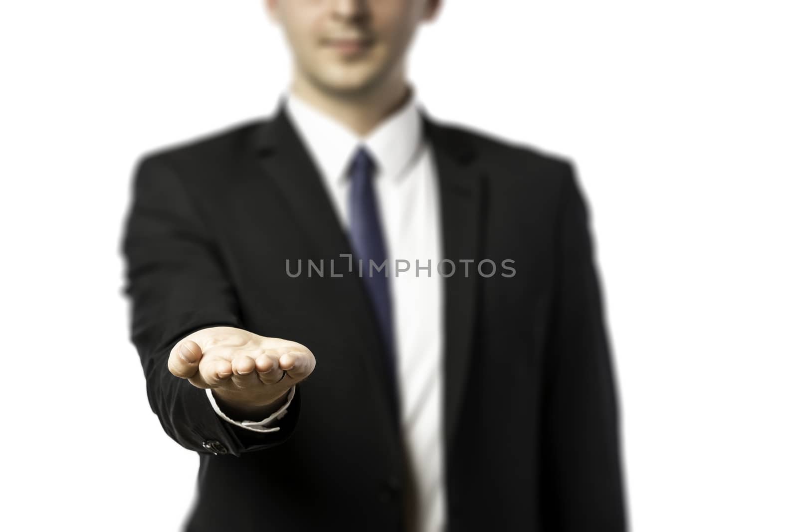 Businessman in dark suit isolated on white background presenting something