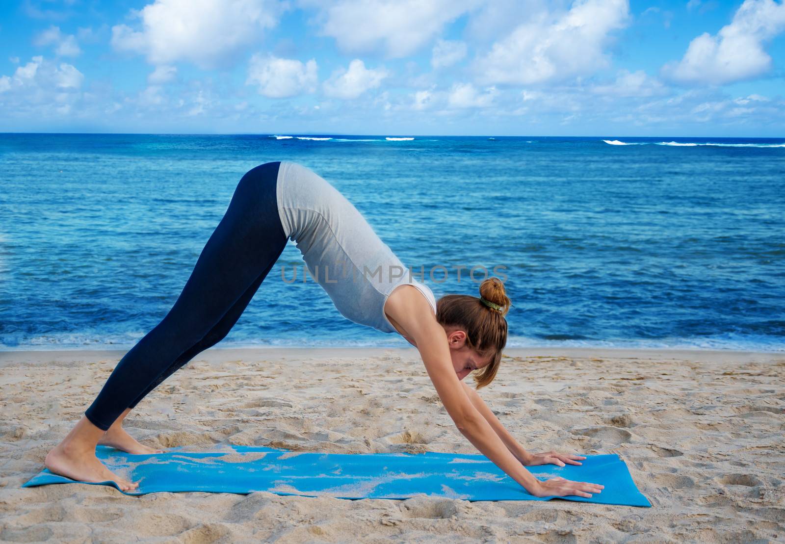 Yang woman practicing yoga by the ocean  by EllenSmile