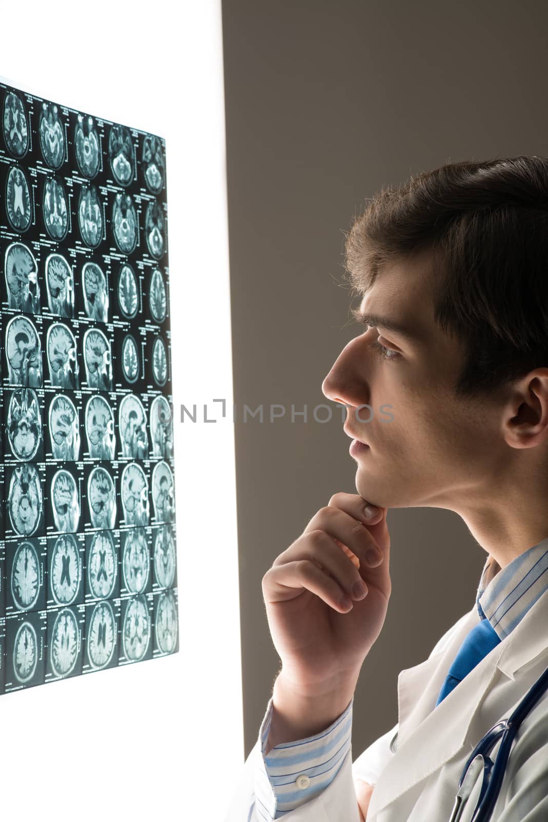 male doctor looking at the x-ray image by adam121