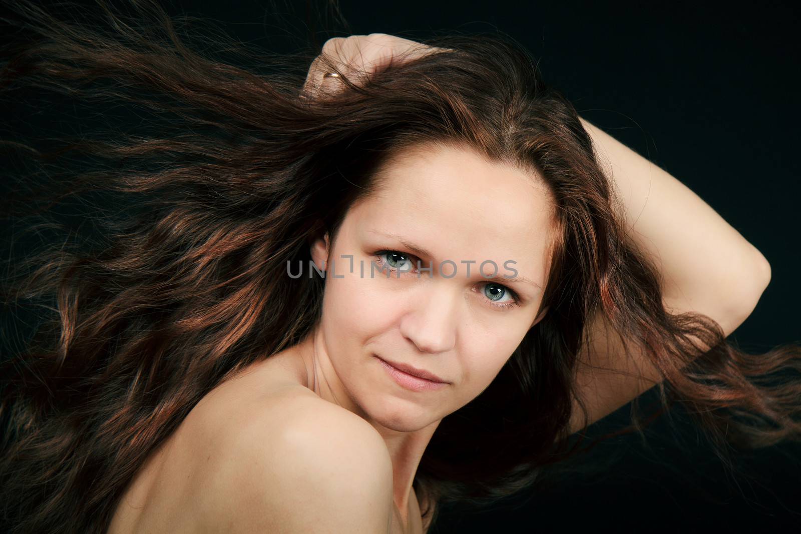 attractive girl with curly hair fluttering in the wind