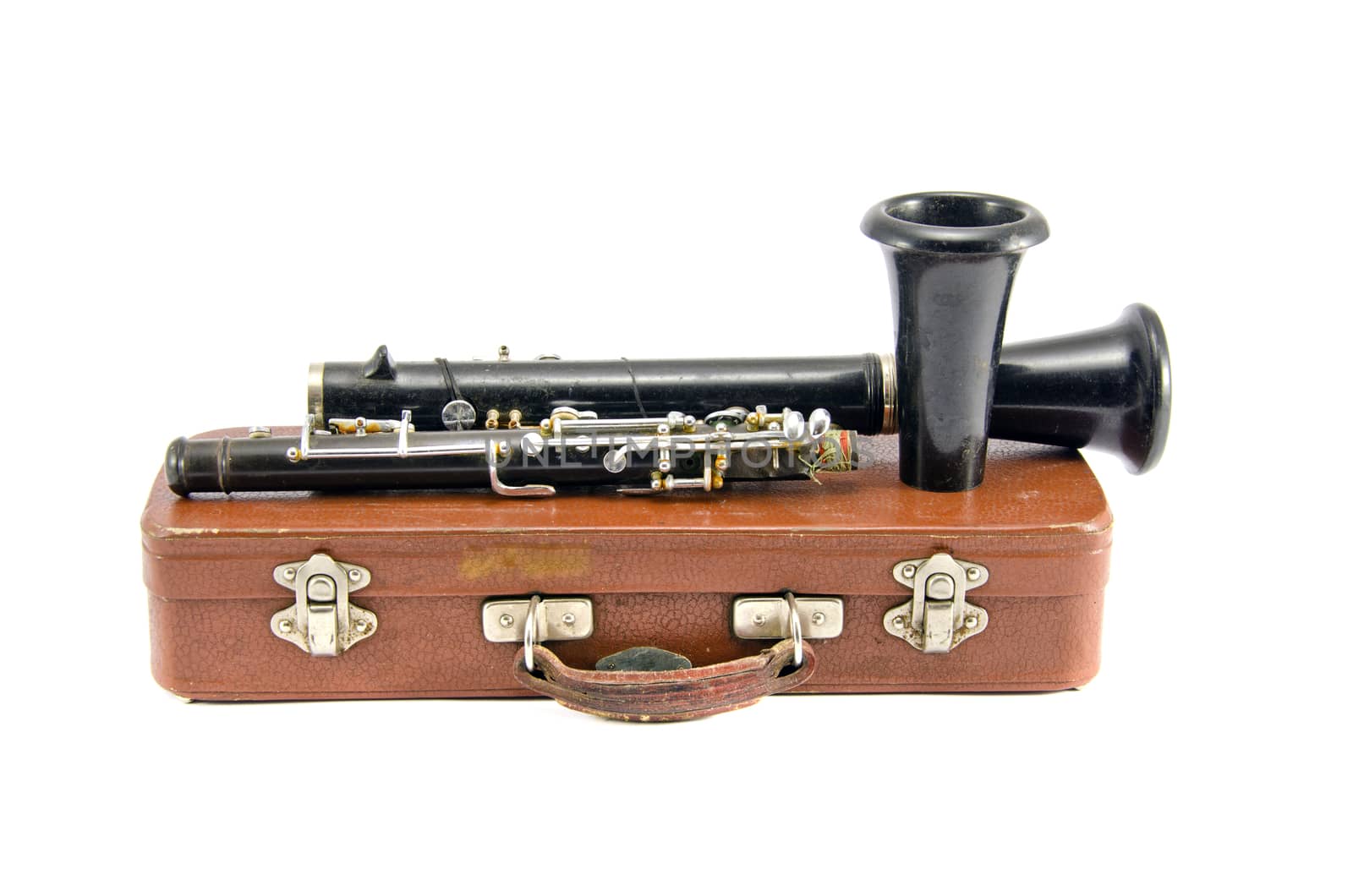 old used clarinet on brown leather box isolated on white background. Musical instrument
