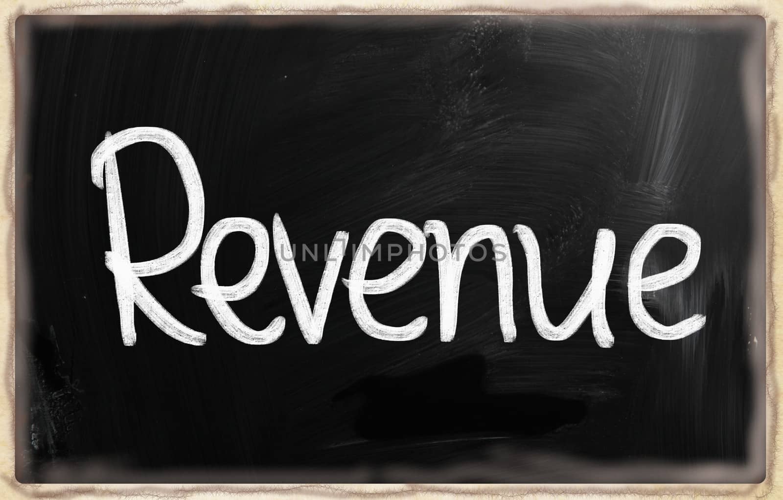 "Revenue" handwritten with white chalk on a blackboard.