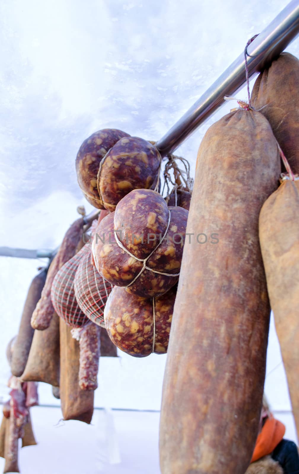 fresh smoked ecologic organic natural meat sausage hang in market fair tent.