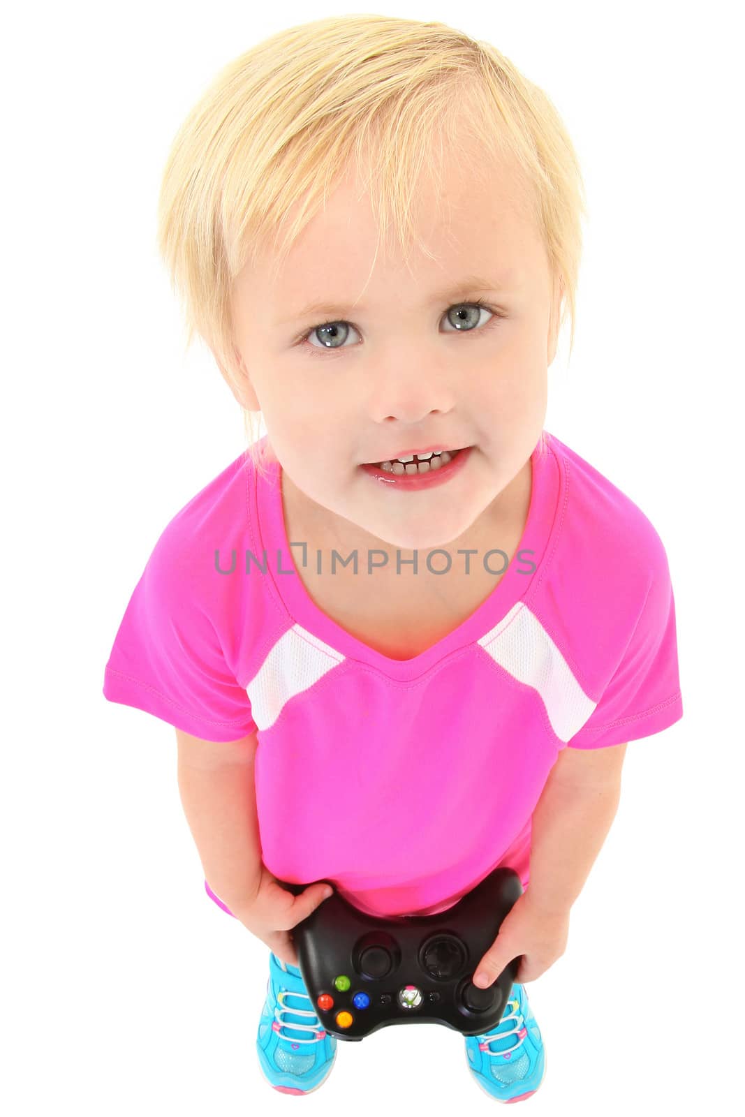 Adorable four year old girl with game controller. Clipping path.
