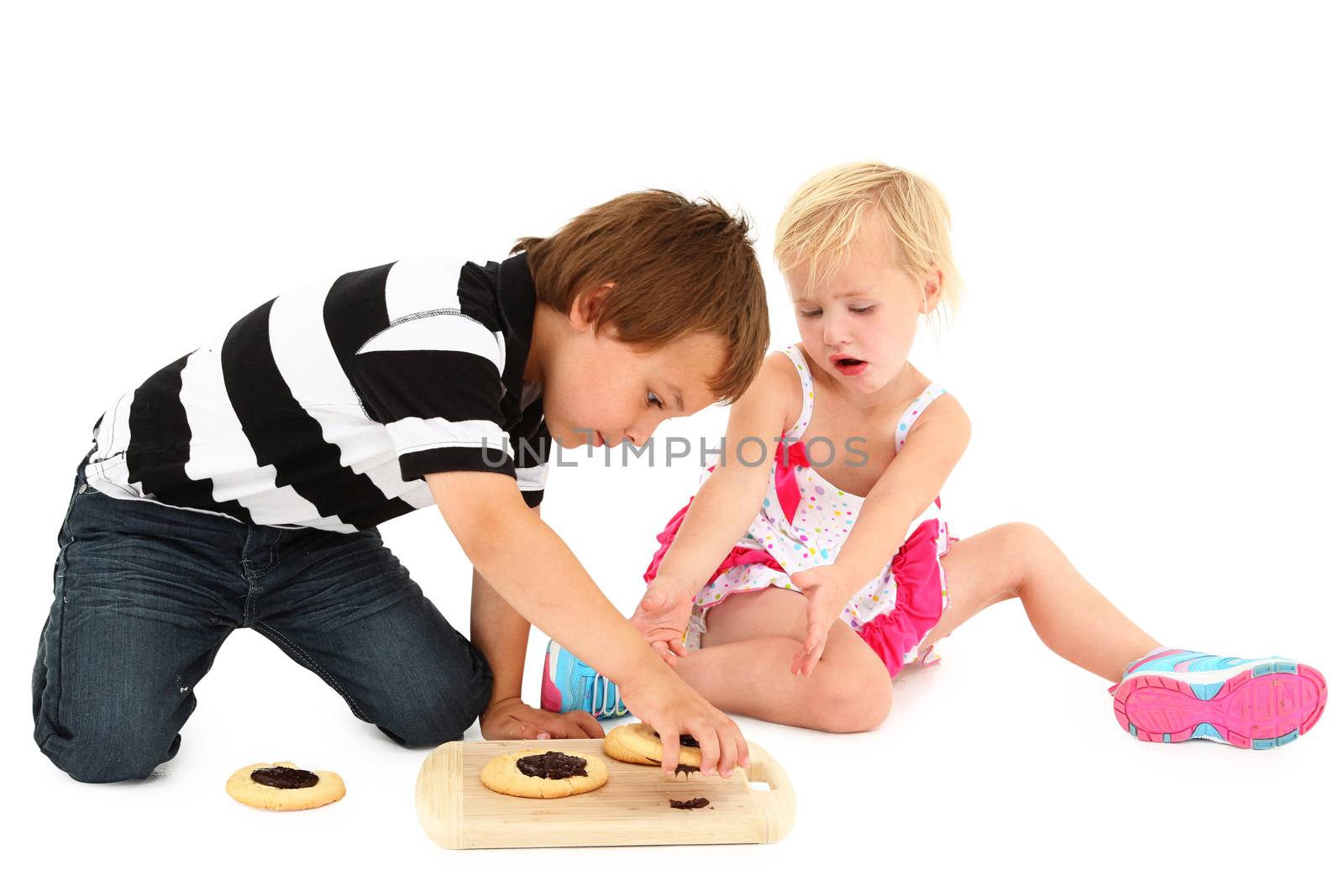 Adorable Caucasian brother with cookies. by duplass