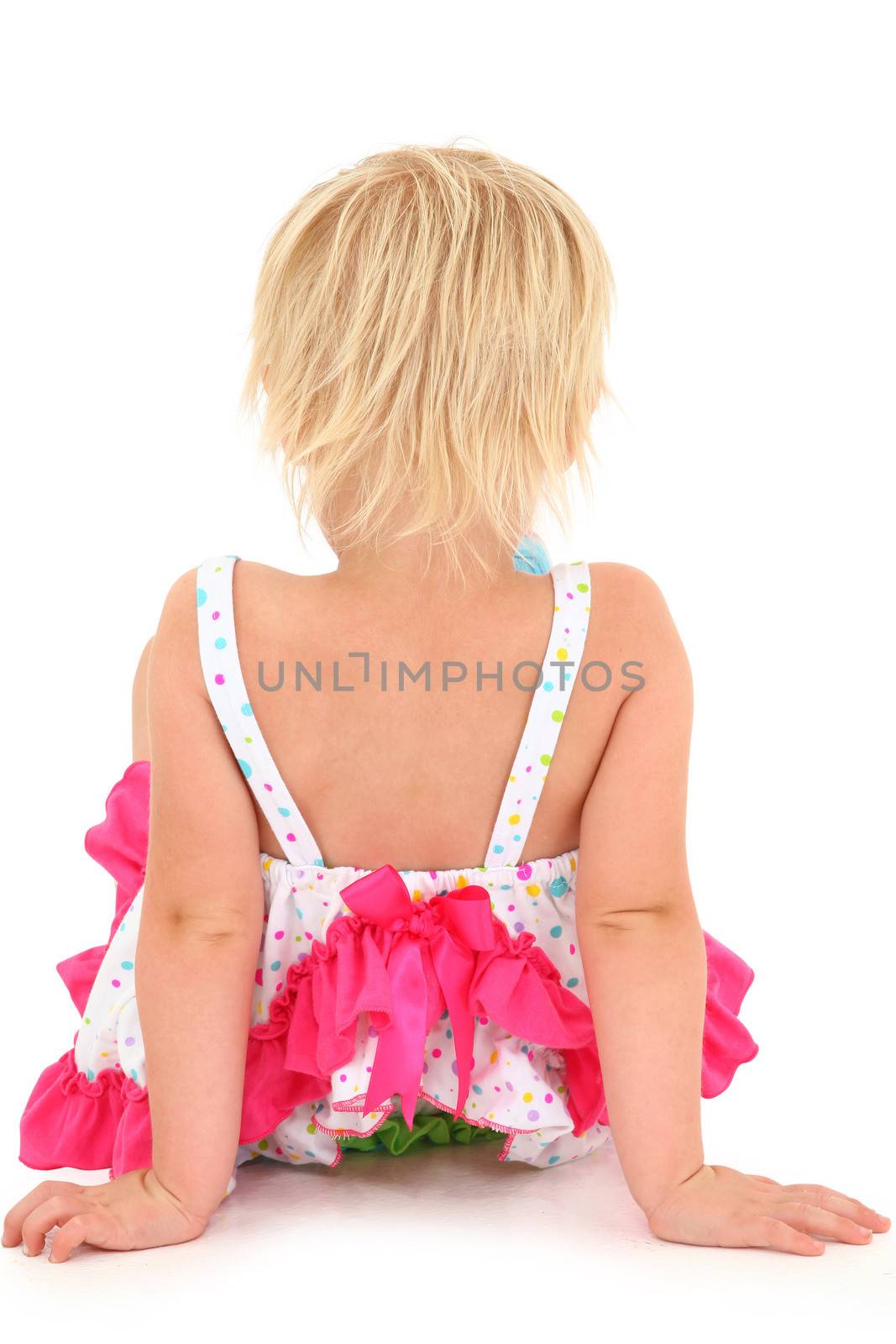 Back side of preschool girl on white background sitting.  Clipping path.