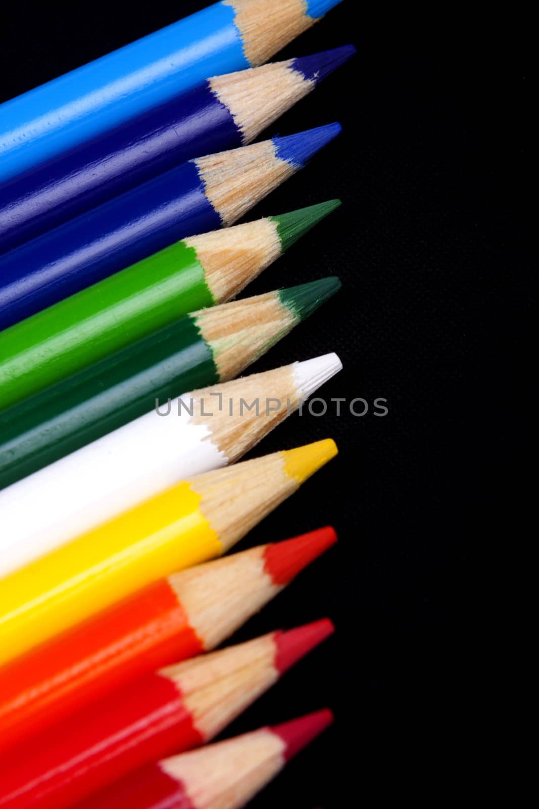 Color pencils isolated on black background