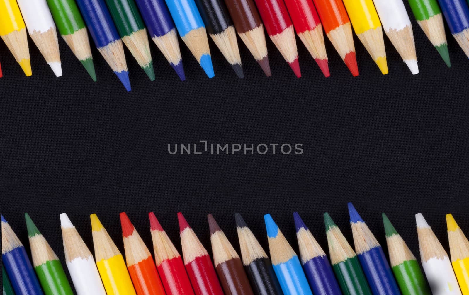 Color pencils isolated on black background