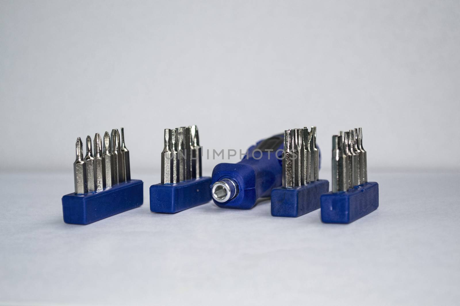 screwdriver and four sets of heads on a white background