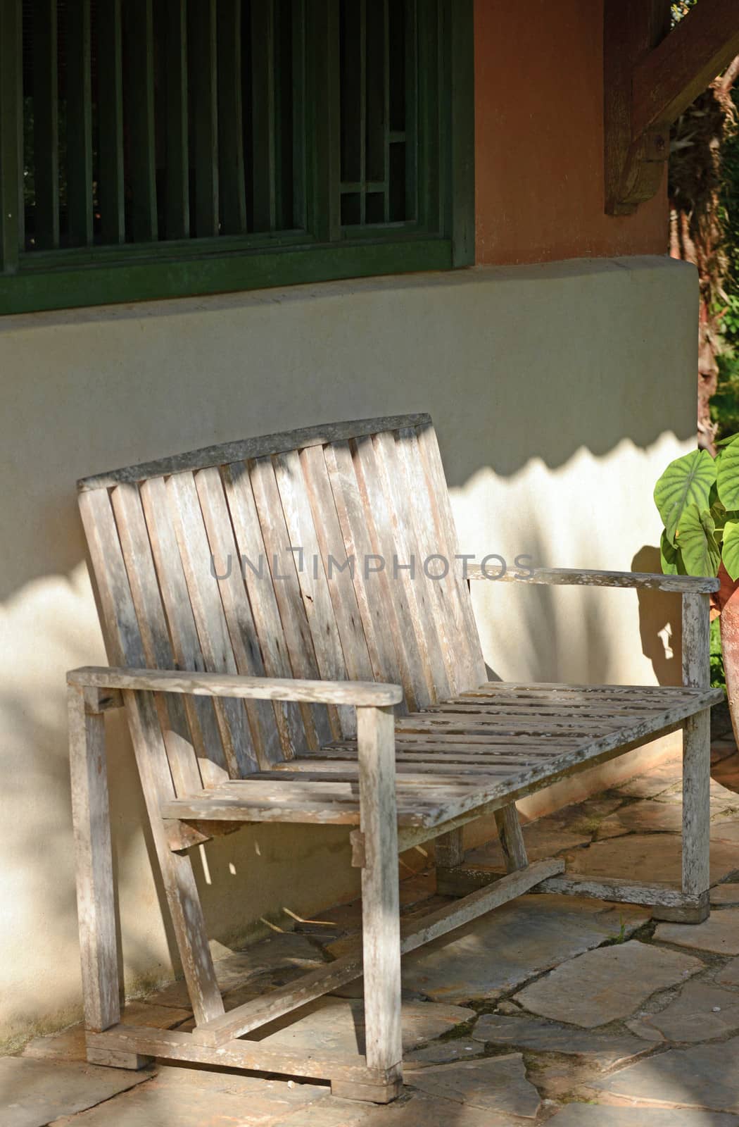 Empty Rustic wooden bench in front of home in panama by ftlaudgirl