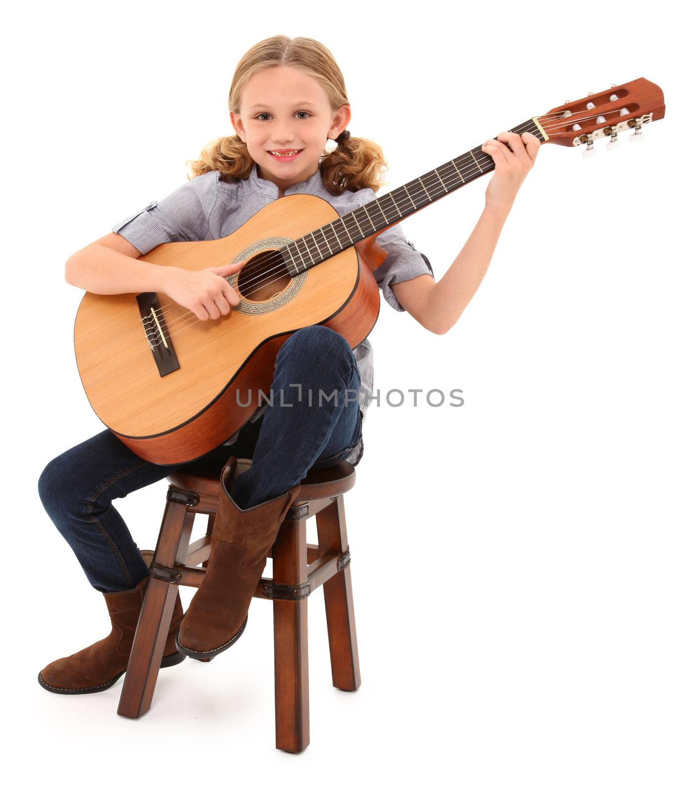 Beautiful ten year old with acoustic guitar over white with clipping path.