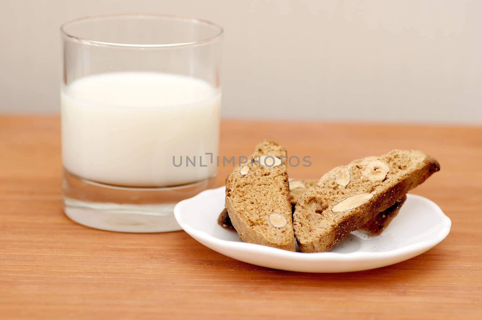 Delicious cantuccini cookies with glass of milk still life