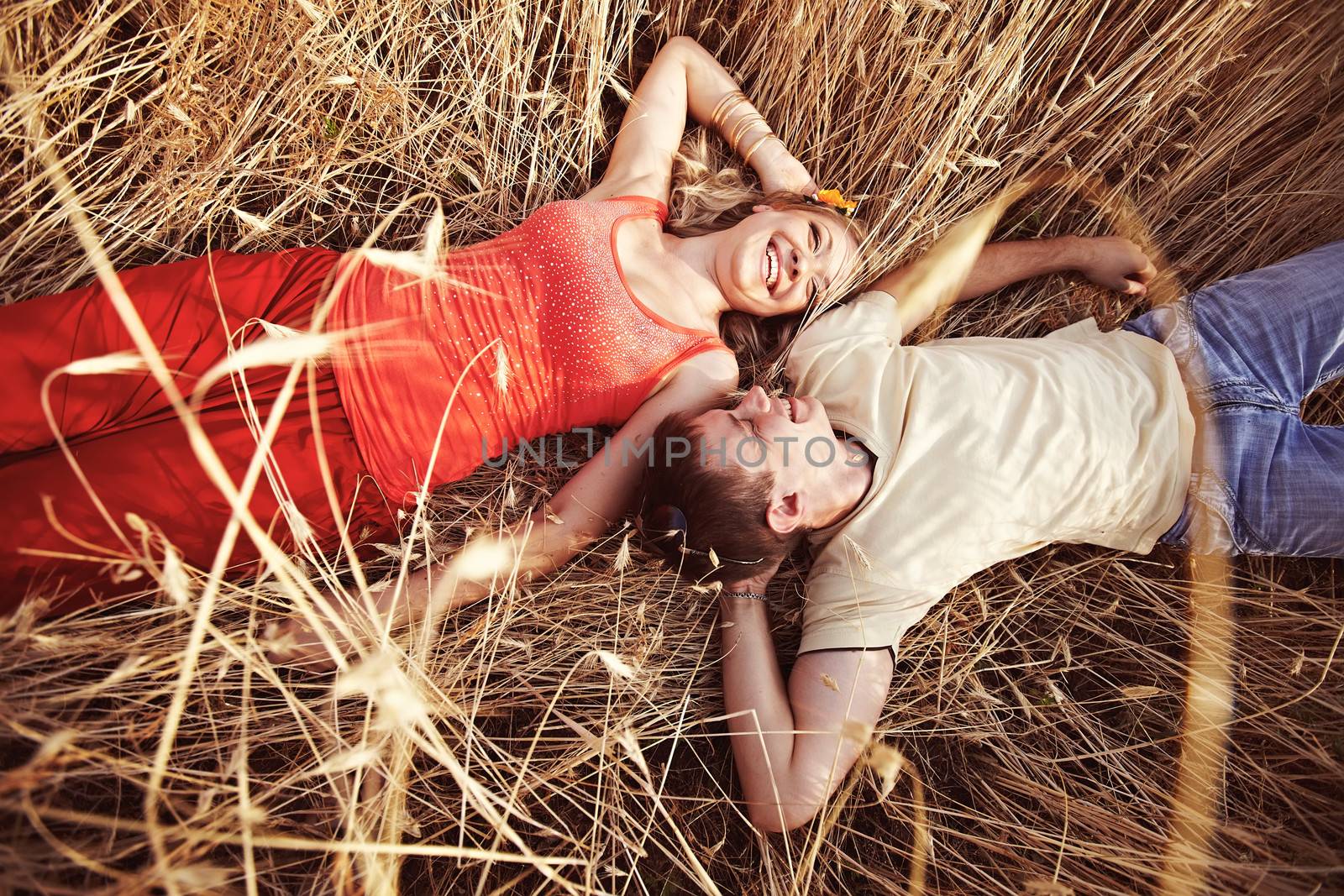 A man and a woman are in a wheat field