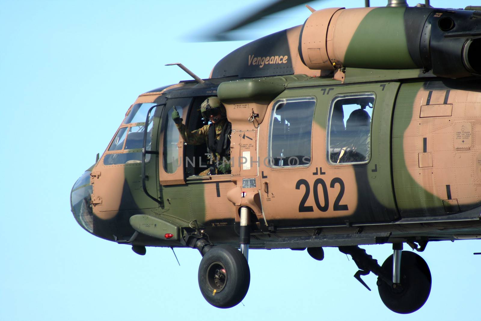 SURFERS PARADISE, Australia - October 26, 2008: Australian Army Blackhawk flies by with soldier giving thumbs up at the Indy 300, Surfers Paradise, Australia.