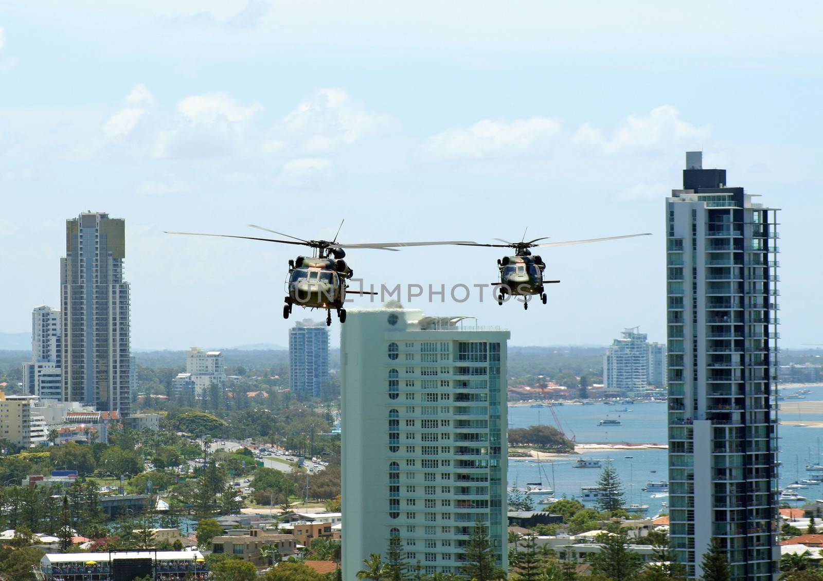 Australian Army Black choppers fly North across Surfers Paradise and the Gold Coast.
